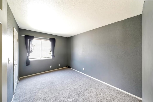 3065 Sabre St, Rosamond, CA 93560 - empty room with a textured wall, a textured ceiling, carpet flooring, and baseboards