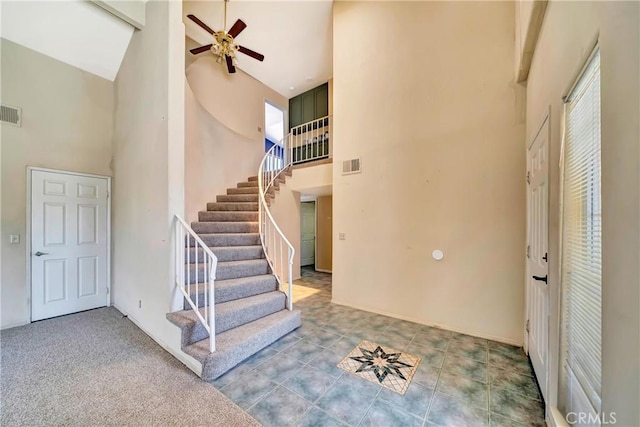 3065 Sabre St, Rosamond, CA 93560 - foyer featuring high vaulted ceiling, ceiling fan, and stairway