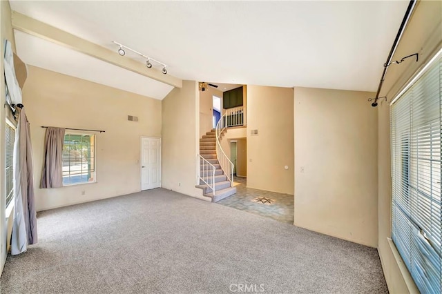 3065 Sabre St, Rosamond, CA 93560 - spare room featuring rail lighting, carpet floors, stairway, a ceiling fan, and high vaulted ceiling