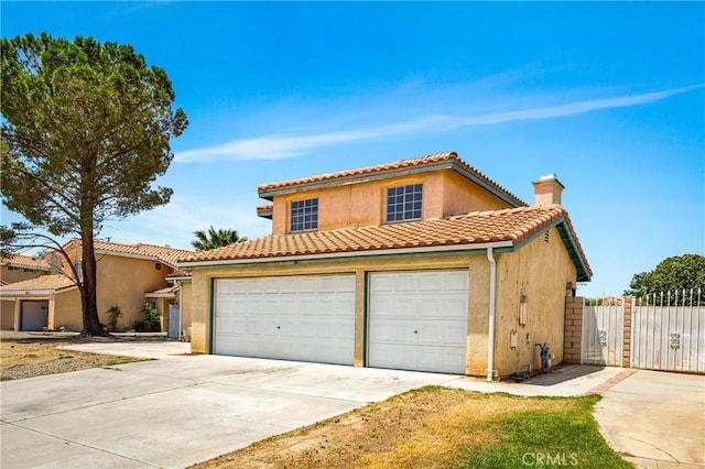 3065 Sabre St, Rosamond, CA 93560 - view of front of property with driveway, stucco siding, a chimney, a gate, and a tiled roof