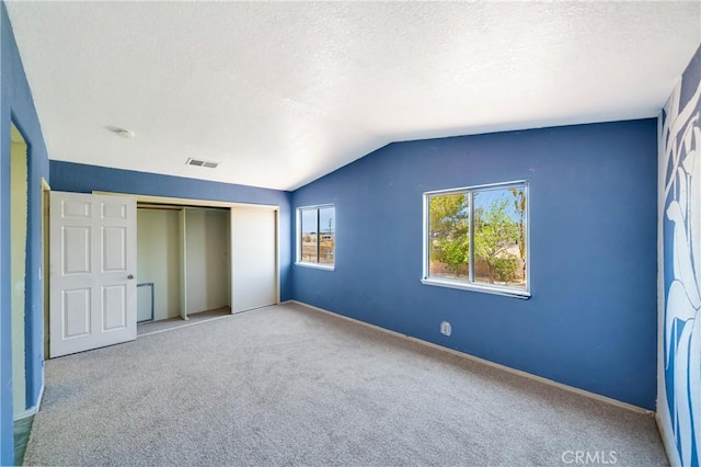 3065 Sabre St, Rosamond, CA 93560 - unfurnished bedroom featuring a textured ceiling, carpet flooring, a closet, lofted ceiling, and baseboards