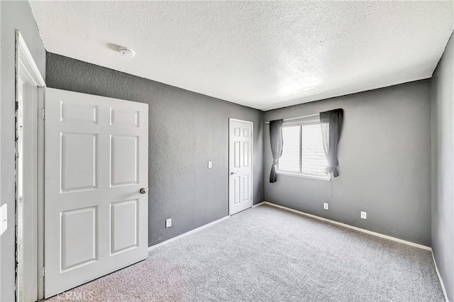 3065 Sabre St, Rosamond, CA 93560 - unfurnished bedroom with a textured ceiling, carpet floors, a closet, baseboards, and a textured wall