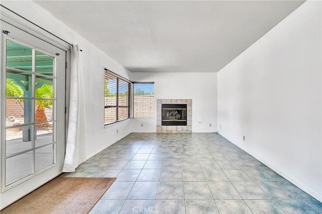 3065 Sabre St, Rosamond, CA 93560 - unfurnished living room featuring tile patterned flooring and a fireplace