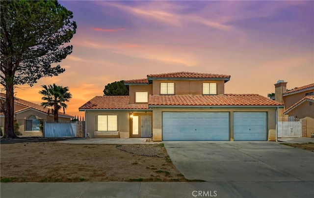 3065 Sabre St, Rosamond, CA 93560 - mediterranean / spanish house with driveway, a tiled roof, stucco siding, and a gate