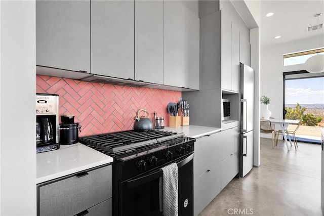 64177 Sullivan Rd, Joshua Tree, CA 92252 - kitchen featuring gas stove, decorative backsplash, freestanding refrigerator, light countertops, and finished concrete floors