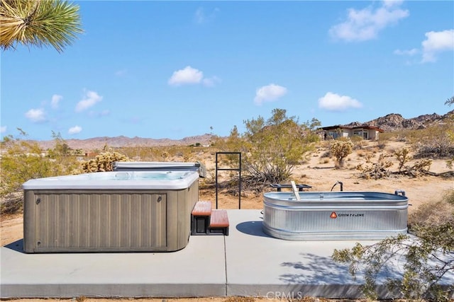 64177 Sullivan Rd, Joshua Tree, CA 92252 - view of patio featuring a hot tub and a mountain view