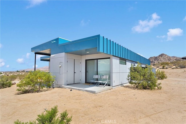 64121 Sullivan Rd, Joshua Tree, CA 92252 - back of house with a mountain view and board and batten siding