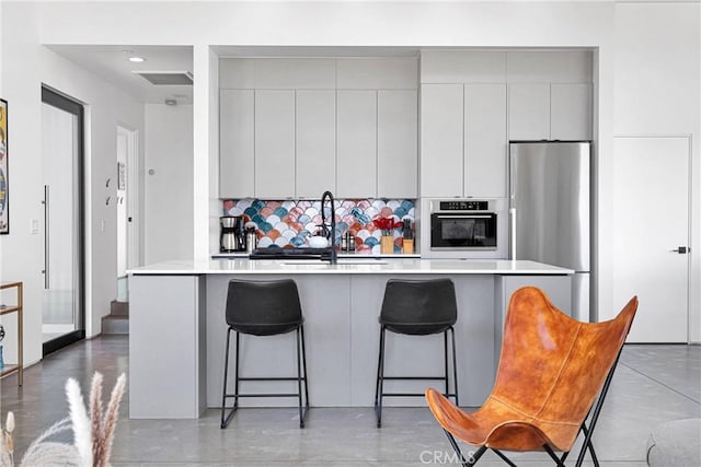 64121 Sullivan Rd, Joshua Tree, CA 92252 - kitchen featuring stainless steel appliances, a sink, light countertops, gray cabinetry, and modern cabinets