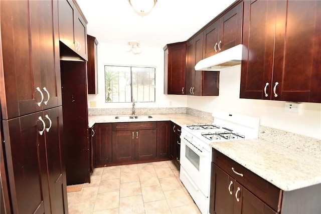 1069 Donahue St, San Diego, CA 92110 - kitchen featuring white gas range, under cabinet range hood, light tile patterned flooring, and light stone counters