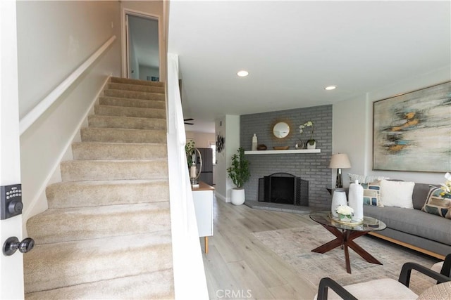 19847 Coventry Ln, Huntington Beach, CA 92646 - stairway featuring wood finished floors, a fireplace, and recessed lighting
