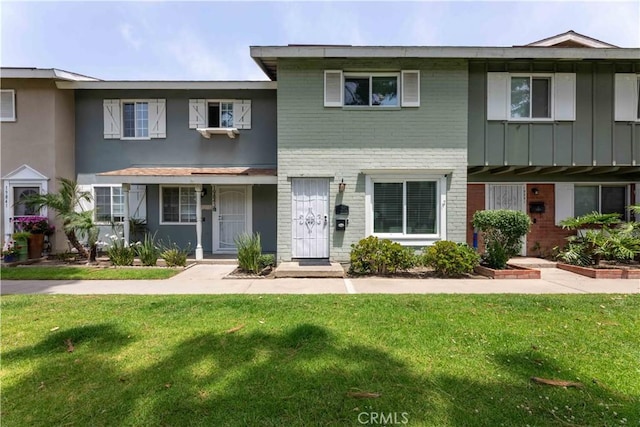 19847 Coventry Ln, Huntington Beach, CA 92646 - view of property featuring brick siding and a front lawn