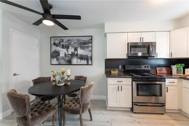 19847 Coventry Ln, Huntington Beach, CA 92646 - kitchen with appliances with stainless steel finishes, light wood finished floors, tasteful backsplash, white cabinetry, and ceiling fan