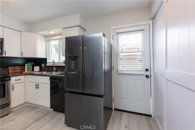 19847 Coventry Ln, Huntington Beach, CA 92646 - kitchen with stainless steel appliances, white cabinets, light wood-style floors, and dark countertops