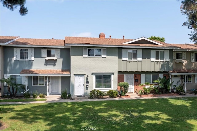 19847 Coventry Ln, Huntington Beach, CA 92646 - view of property with a chimney, a front yard, and brick siding