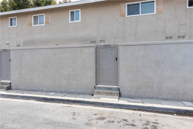 19847 Coventry Ln, Huntington Beach, CA 92646 - doorway to property featuring a gate and stucco siding