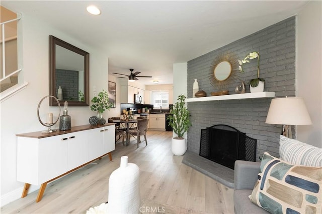 19847 Coventry Ln, Huntington Beach, CA 92646 - living area featuring light wood-type flooring, ceiling fan, a brick fireplace, and recessed lighting