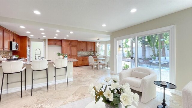 4 Salerno, Irvine, CA 92614 - kitchen with recessed lighting, a peninsula, stainless steel appliances, decorative backsplash, and light countertops