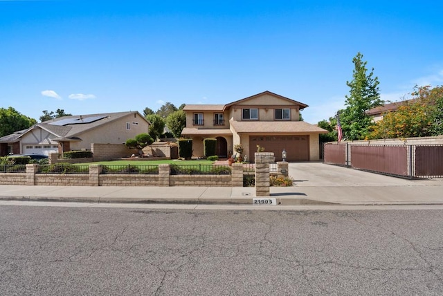 21905 Grovepark Dr, Saugus, CA 91350 - traditional-style home with a fenced front yard, driveway, a garage, and stucco siding