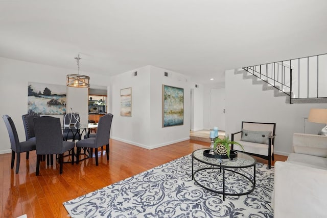 21905 Grovepark Dr, Saugus, CA 91350 - living room with light wood-style flooring, baseboards, and stairs