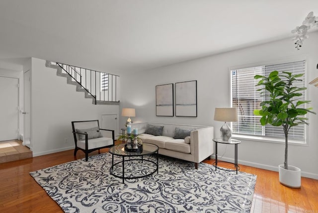 21905 Grovepark Dr, Saugus, CA 91350 - living room with wood finished floors, stairway, and baseboards