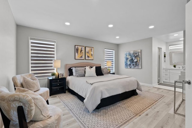 21905 Grovepark Dr, Saugus, CA 91350 - bedroom featuring light wood-style floors, recessed lighting, connected bathroom, and baseboards