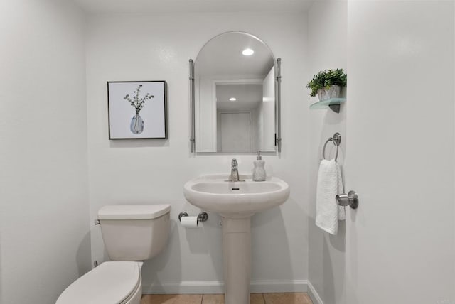 21905 Grovepark Dr, Saugus, CA 91350 - half bath featuring toilet, baseboards, and tile patterned flooring