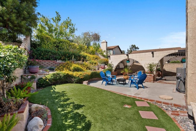 21905 Grovepark Dr, Saugus, CA 91350 - view of grassy yard with a patio area and an outdoor fire pit