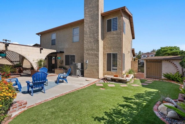 21905 Grovepark Dr, Saugus, CA 91350 - rear view of house with a patio, stucco siding, and a gate