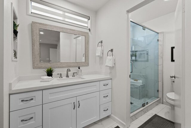 21905 Grovepark Dr, Saugus, CA 91350 - bathroom featuring marble finish floors, a marble finish shower, and vanity