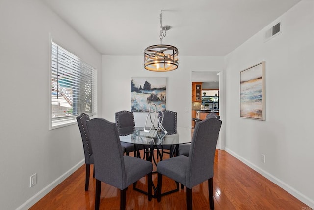 21905 Grovepark Dr, Saugus, CA 91350 - dining area featuring wood finished floors and a chandelier
