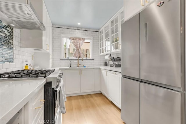 534 E Hazel St Unit 5, Inglewood, CA 90302 - kitchen featuring appliances with stainless steel finishes, custom range hood, light countertops, tasteful backsplash, and recessed lighting