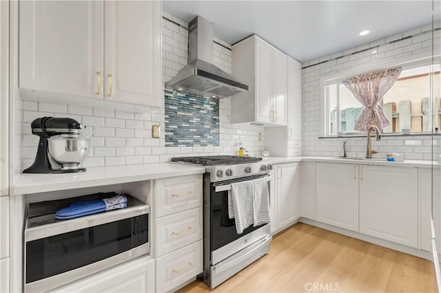 534 E Hazel St Unit 5, Inglewood, CA 90302 - kitchen with stainless steel appliances, wall chimney range hood, a sink, light countertops, and tasteful backsplash