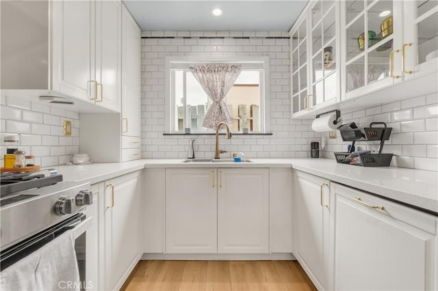 534 E Hazel St Unit 5, Inglewood, CA 90302 - kitchen with a sink, stainless steel range oven, backsplash, white cabinets, and recessed lighting