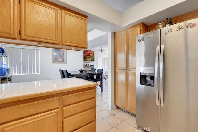 24880 Balestrieri Rd, Hemet, CA 92544 - kitchen with stainless steel refrigerator with ice dispenser, tile counters, light tile patterned floors, and a ceiling fan