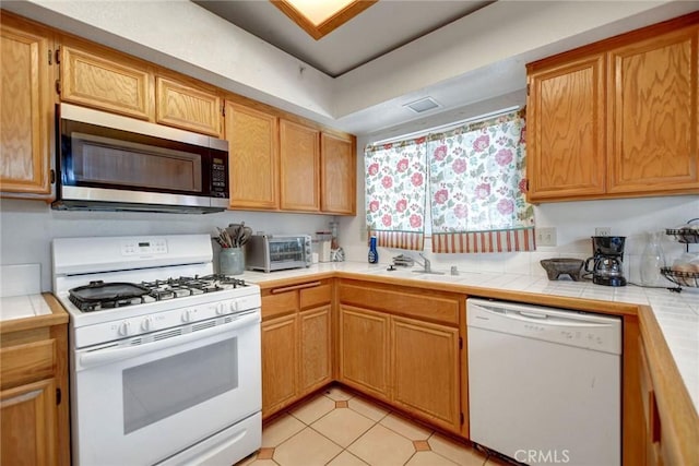 24880 Balestrieri Rd, Hemet, CA 92544 - kitchen with white appliances, a sink, tile countertops, and light tile patterned flooring