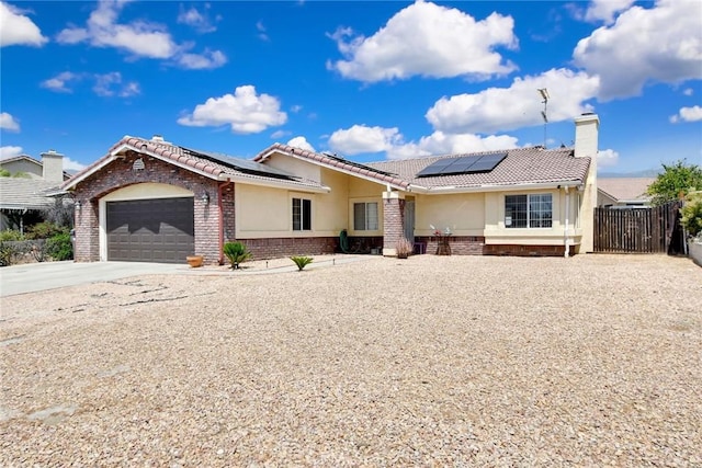 24880 Balestrieri Rd, Hemet, CA 92544 - ranch-style house featuring driveway, stucco siding, a tiled roof, and solar panels