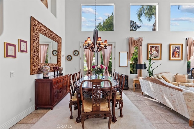 22440 Skylake Pl, Saugus, CA 91390 - dining area featuring a chandelier, a towering ceiling, healthy amount of natural light, baseboards, and light tile patterned floors