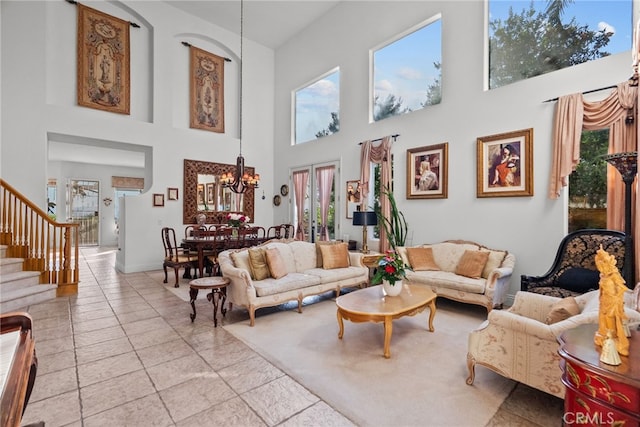 22440 Skylake Pl, Saugus, CA 91390 - living room with a chandelier, healthy amount of natural light, a high ceiling, stairway, and light tile patterned flooring