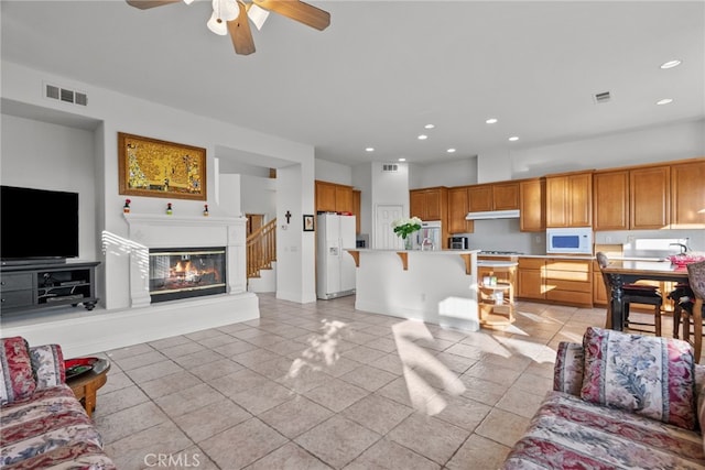 22440 Skylake Pl, Saugus, CA 91390 - living room with light tile patterned floors, ceiling fan, recessed lighting, and a glass covered fireplace