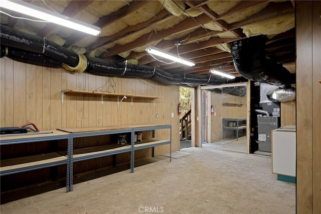 26350 Spyglass Dr, Lake Arrowhead, CA 92352 - unfinished below grade area with wood walls, heating unit, and a workshop area