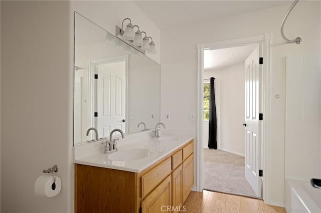 26350 Spyglass Dr, Lake Arrowhead, CA 92352 - bathroom featuring double vanity, wood finished floors, bathtub / shower combination, and baseboards