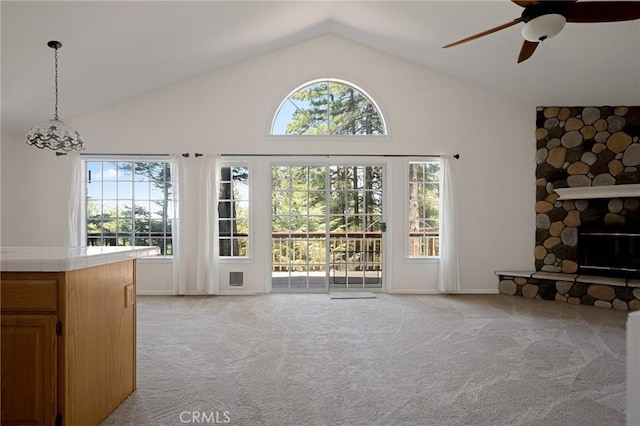 26350 Spyglass Dr, Lake Arrowhead, CA 92352 - unfurnished living room featuring light colored carpet, a ceiling fan, a fireplace, and high vaulted ceiling