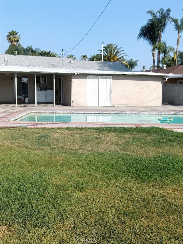 16614 Samgerry Dr, La Puente, CA 91744 - rear view of house with a yard, an outdoor pool, and stucco siding