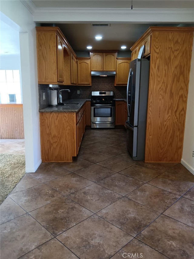 16614 Samgerry Dr, La Puente, CA 91744 - kitchen featuring stainless steel appliances, under cabinet range hood, ornamental molding, dark countertops, and tasteful backsplash