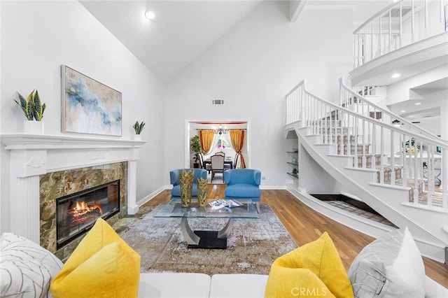 338 Laurel Ave, Arcadia, CA 91006 - living area featuring a fireplace, stairway, high vaulted ceiling, wood finished floors, and baseboards