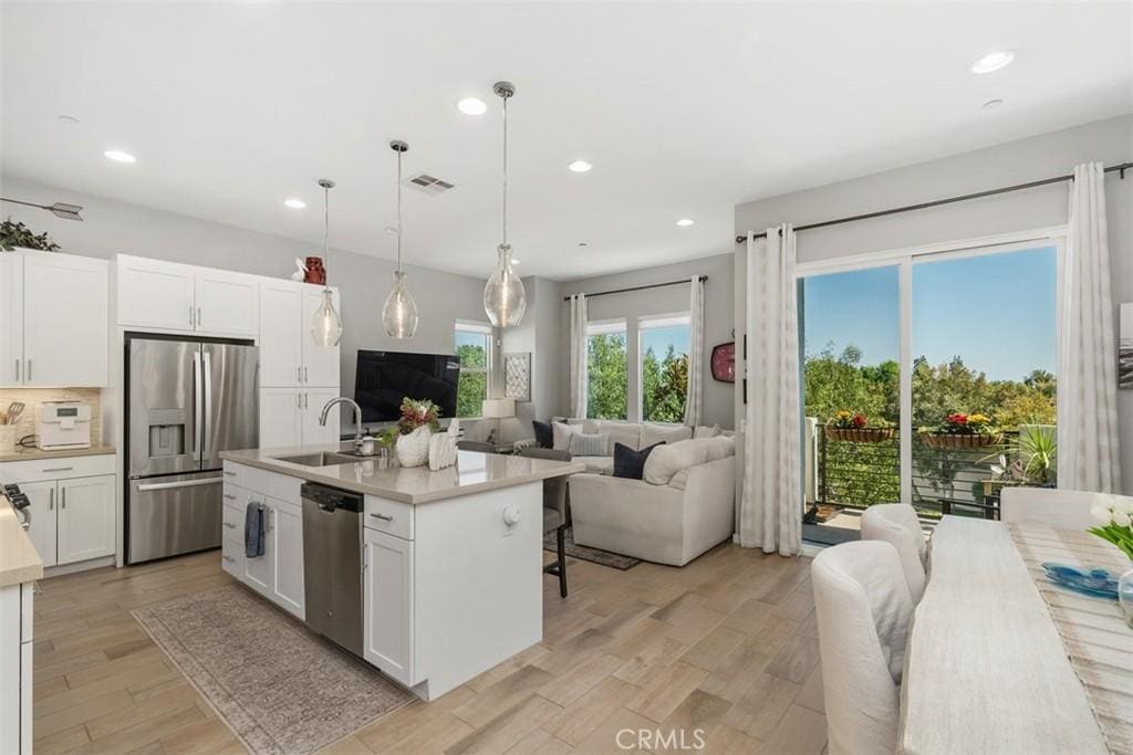 432 Broadway, Brea, CA 92821 - kitchen featuring appliances with stainless steel finishes, open floor plan, recessed lighting, light countertops, and white cabinetry