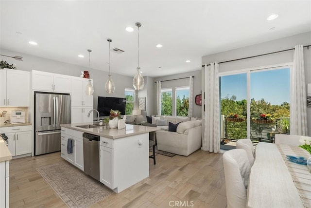 432 Broadway, Brea, CA 92821 - kitchen featuring appliances with stainless steel finishes, open floor plan, recessed lighting, light countertops, and white cabinetry