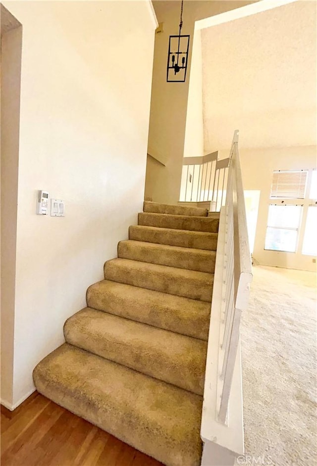 23878 Bouquet Canyon Pl, Moreno Valley, CA 92557 - stairway with wood finished floors and baseboards