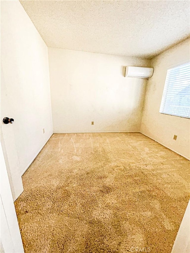 23878 Bouquet Canyon Pl, Moreno Valley, CA 92557 - empty room with a wall mounted AC, a textured ceiling, and carpet floors