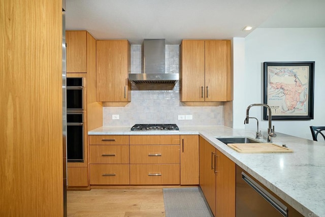 325 7th Unit 1501, San Diego, CA 92101 - kitchen with wall chimney exhaust hood, appliances with stainless steel finishes, a sink, light wood-type flooring, and tasteful backsplash